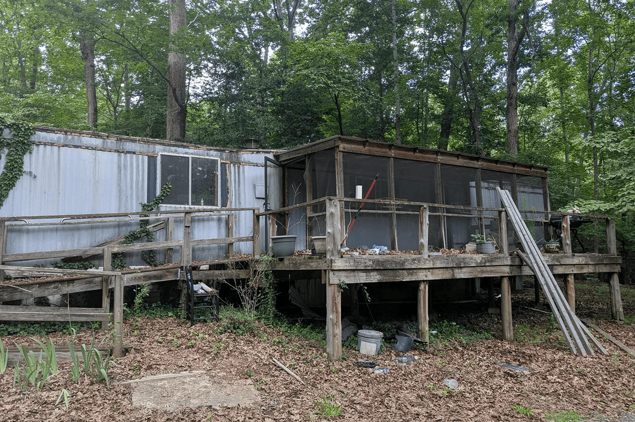 Before demolition — old structure and debris on site