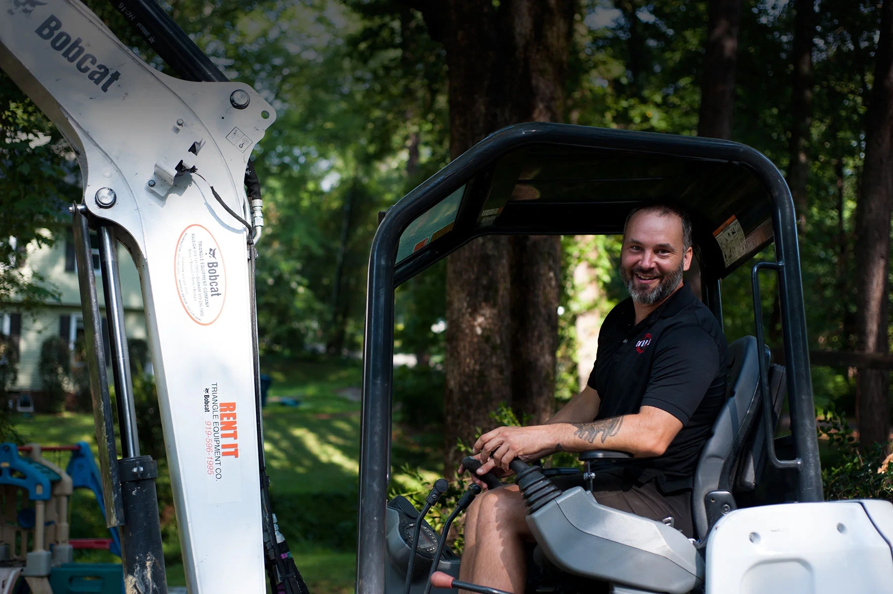 Compact track loader on residential demolition site
